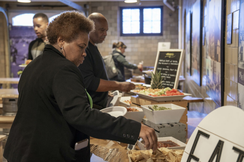 woman choosing an appetizer from the buffet