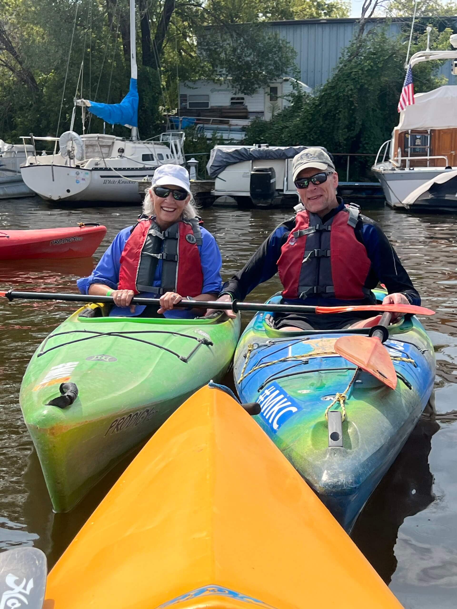 IMG_1560 A pair of kayakers next to each other smiling at the camera